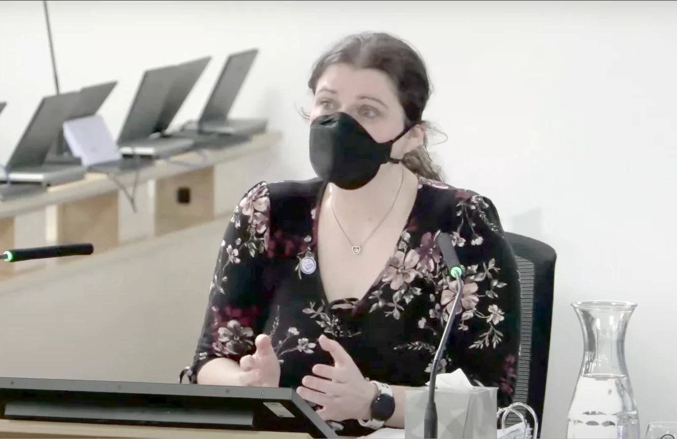 Lara Wong, wearing a black face mask, gives evidence at a hearing table at the UK Covid-19 Inquiry.