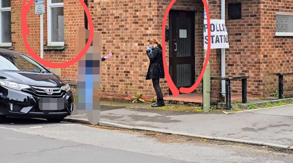 Polling station entrance with a masked voter outside; red circles mark the closed front door and a closed window