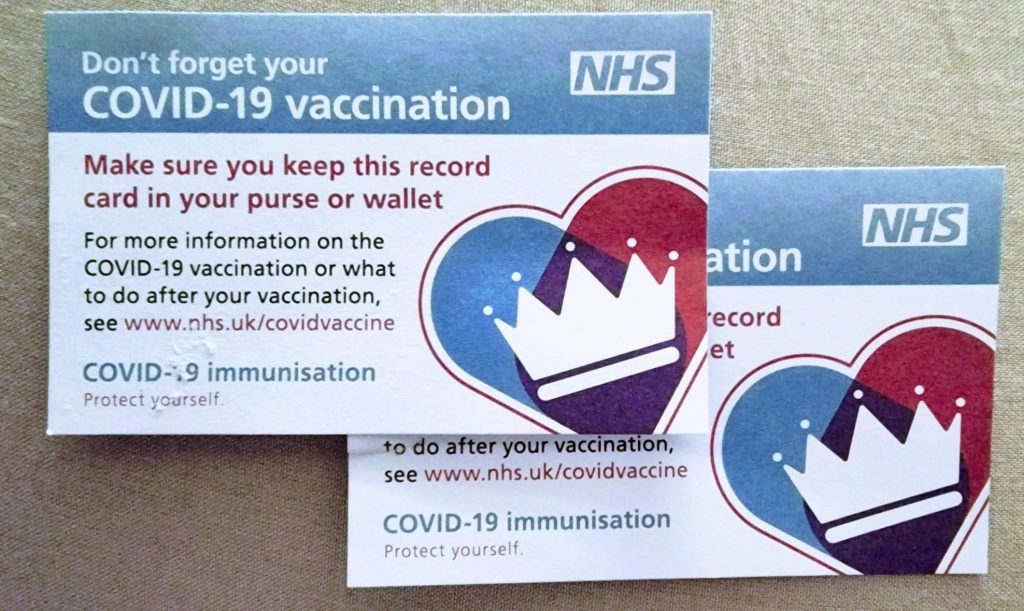 Two NHS Covid-19 vaccination record cards