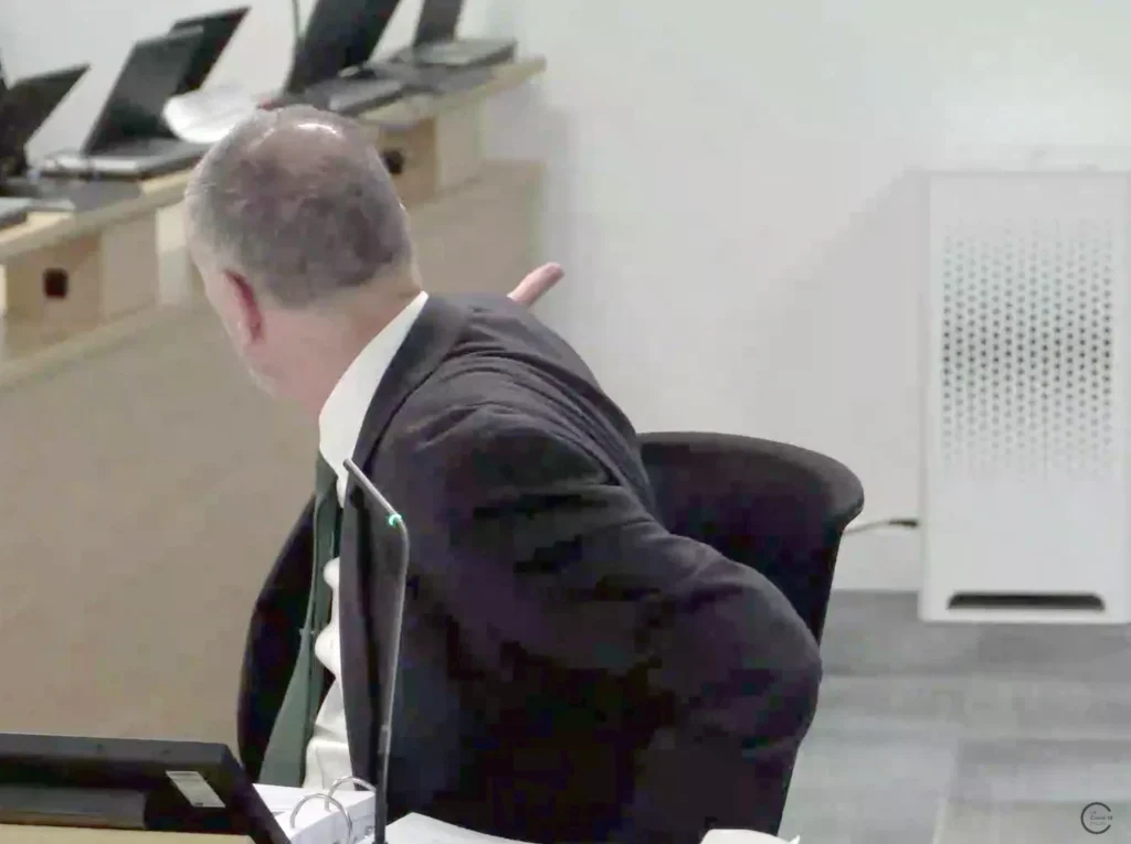 Professor Clive Beggs, an expert witness to the UK Covid-19 Inquiry, turns to point at a HEPA air filter standing in the hearing room.